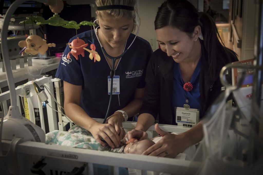 Galen College students practice with an infant patient.